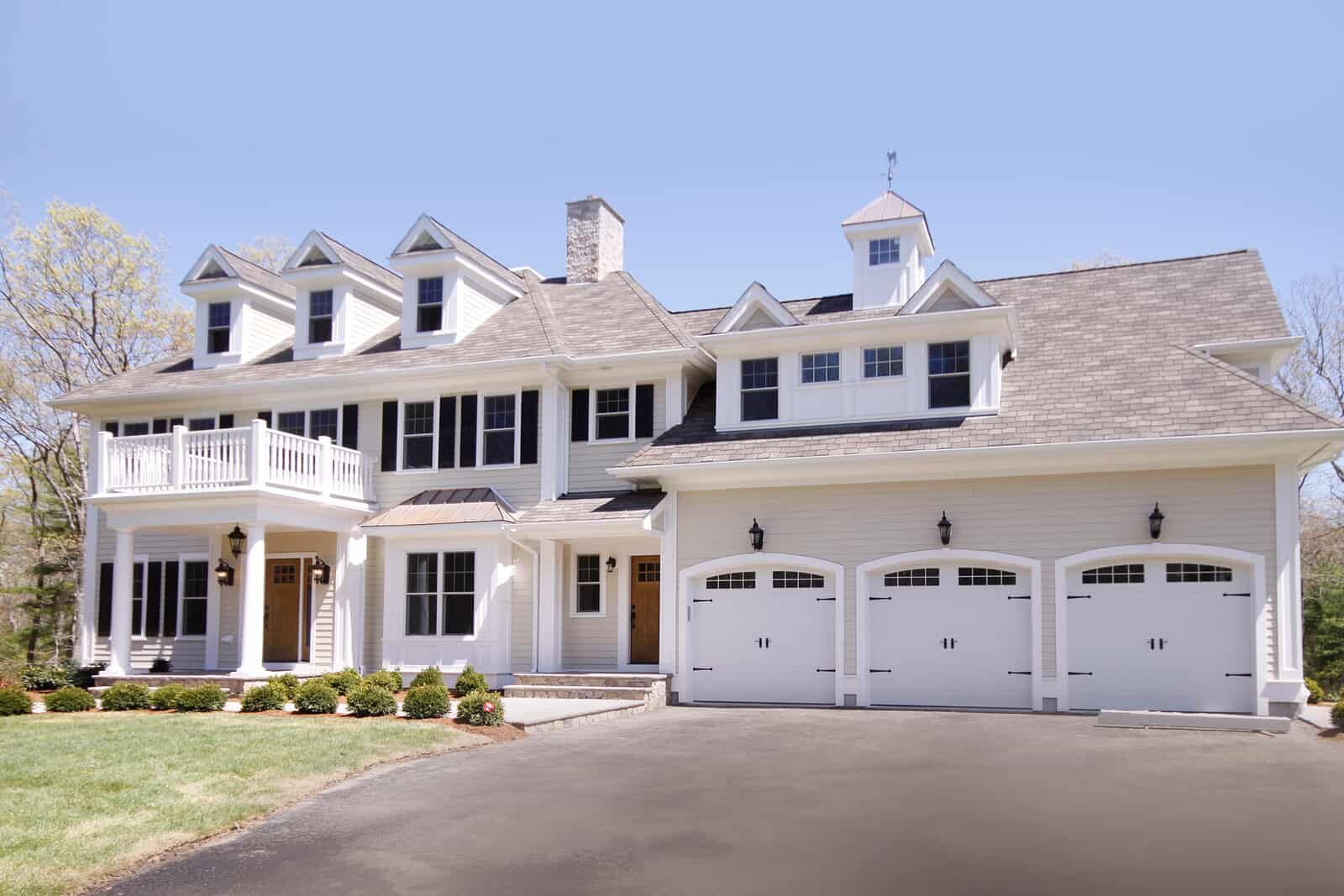 White colonial-style custom home in Dedham, MA by Supreme Companies