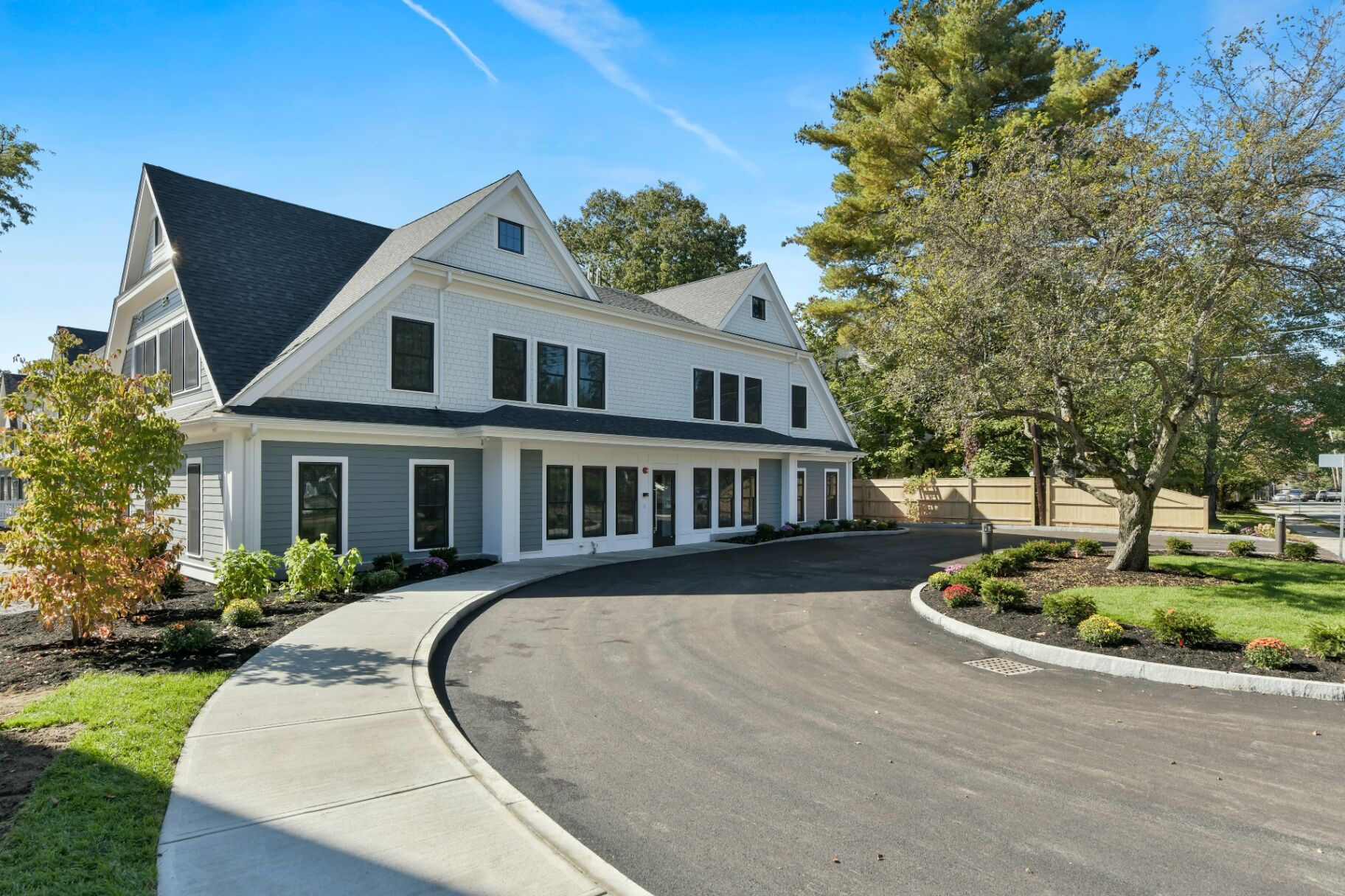 Shingle-style residential building with a curved driveway